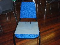 The seating wedge on the seat which helps the boy to maintain his core stability and helps him to sit forward in his seat